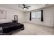 Spacious main bedroom featuring carpeted floors and a large window at 40213 W James Ln, Maricopa, AZ 85138