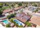 Expansive aerial view of a home with a private pool, solar panels, and a nearby golf course at 4353 W Villa Rita Dr, Glendale, AZ 85308