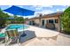 Serene backyard with a sparkling pool, large patio, and lush landscaping for outdoor enjoyment at 4353 W Villa Rita Dr, Glendale, AZ 85308
