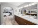 Beautiful bathroom with a large double sink vanity, tile flooring, and an archway to the main bedroom at 4353 W Villa Rita Dr, Glendale, AZ 85308