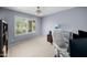 Spare bedroom with neutral walls, a window with plantation shutters and dedicated office space at 4353 W Villa Rita Dr, Glendale, AZ 85308