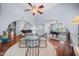 Open dining room with glass table, stylish chairs, hardwood floors, and pool table room in background at 4353 W Villa Rita Dr, Glendale, AZ 85308