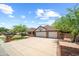 Beautiful home with brick accents, a lush lawn, and a large driveway leading to a two-car garage at 4353 W Villa Rita Dr, Glendale, AZ 85308
