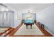 Spacious game room with a pool table, light-filled windows, and warm hardwood floors at 4353 W Villa Rita Dr, Glendale, AZ 85308