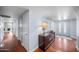 Hallway featuring hardwood floors, fresh paint, modern lighting, and access to various rooms at 4353 W Villa Rita Dr, Glendale, AZ 85308