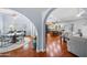 Open-concept living space with hardwood floors, arched doorways, dining, and kitchen areas for seamless entertaining at 4353 W Villa Rita Dr, Glendale, AZ 85308