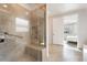 Elegant bathroom with a walk-in shower, neutral tiling, and accessibility features for added convenience at 4360 N 186Th Ln, Goodyear, AZ 85395