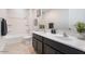 Bathroom featuring a double vanity, framed mirrors, and a shower-tub combo at 4360 N 186Th Ln, Goodyear, AZ 85395