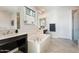 Luxurious bathroom featuring a soaking tub, double sinks, and a separate shower with modern fixtures at 4360 N 186Th Ln, Goodyear, AZ 85395