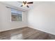 Empty bedroom with hardwood floors and a large window at 4360 N 186Th Ln, Goodyear, AZ 85395