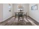 Dining area with modern chandelier, table set for four, and plenty of natural light at 4360 N 186Th Ln, Goodyear, AZ 85395