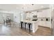 Open kitchen featuring an island with bar seating, stainless steel appliances and a dining area in a spacious layout at 4360 N 186Th Ln, Goodyear, AZ 85395