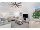 Bright living room featuring neutral decor, ceiling fan, and comfortable seating area at 4360 N 186Th Ln, Goodyear, AZ 85395