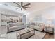 Bright living room with comfortable seating, stylish decor, and an open view to the kitchen at 4360 N 186Th Ln, Goodyear, AZ 85395