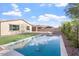 Backyard featuring a private pool, well-maintained lawn, desert landscaping, and block fence at 4360 N 186Th Ln, Goodyear, AZ 85395