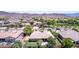 A home in a quiet neighborhood boasts mature trees and landscaping with mountain views in the distance at 4404 W Olney Ave, Laveen, AZ 85339