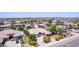 Stunning aerial view showcasing a home with a three-car garage and landscaped front yard in a suburban setting at 4404 W Olney Ave, Laveen, AZ 85339