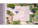 Aerial view of single-Gathering home featuring a large roof, well-manicured backyard, a pool and a long driveway at 4404 W Olney Ave, Laveen, AZ 85339