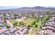 An expansive aerial view shows the community park with a playground, basketball court, grassy fields, and homes at 4404 W Olney Ave, Laveen, AZ 85339