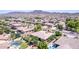 Expansive aerial view showcasing homes with pools and lush landscaping, set against a stunning mountain backdrop at 4404 W Olney Ave, Laveen, AZ 85339
