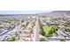 An aerial view of the community shows the tree-lined streets, grassy fields, and desert landscaping at 4404 W Olney Ave, Laveen, AZ 85339