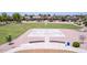 Aerial view of a community basketball court and walking path bordered by lush landscaping and neighborhood homes at 4404 W Olney Ave, Laveen, AZ 85339