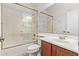 Bathroom featuring a tub/shower, single sink vanity, and mirrored wall at 4404 W Olney Ave, Laveen, AZ 85339