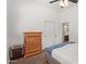 Bedroom with carpet, dresser, sliding closet, and view into en-suite bathroom at 4404 W Olney Ave, Laveen, AZ 85339