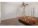 Large bedroom with ceiling fan, plush carpet, and multiple windows at 4404 W Olney Ave, Laveen, AZ 85339
