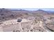 Construction site aerial view showing desert landscaping, parking, amphitheater, and distant mountain views at 4404 W Olney Ave, Laveen, AZ 85339
