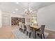 Elegant dining room with seating for eight, a modern chandelier, and views of the landscaped yard at 4404 W Olney Ave, Laveen, AZ 85339