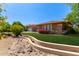 Inviting one-story home with a lush lawn and colorful flowers, showcasing its charming curb appeal at 4404 W Olney Ave, Laveen, AZ 85339