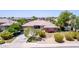 Charming home boasts mature trees, colorful flower beds, and a well-maintained lawn, creating a welcoming curb appeal at 4404 W Olney Ave, Laveen, AZ 85339
