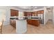 Spacious kitchen boasts wood cabinets, granite countertops, stainless steel appliances, and a central island at 4404 W Olney Ave, Laveen, AZ 85339