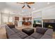 Open concept living room featuring a fireplace, TV, a view of the kitchen, and a large gray sofa at 4404 W Olney Ave, Laveen, AZ 85339