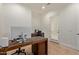 Bright office space featuring tile flooring, a wooden desk with computer, and natural light from the door at 4404 W Olney Ave, Laveen, AZ 85339