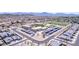 Aerial view of the school, showcasing solar panel carports, sports fields, and a playground within the residential community at 4404 W Olney Ave, Laveen, AZ 85339