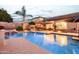 Beautiful backyard with a swimming pool, outdoor kitchen, covered patio, and lush landscaping at 4422 E Spur Dr, Cave Creek, AZ 85331