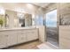 Modern bathroom featuring a double sink vanity, a large mirror, and a glass-enclosed shower at 4422 E Spur Dr, Cave Creek, AZ 85331