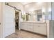 Elegant bathroom with dual sinks, quartz countertops, modern fixtures, and walk in closet at 4422 E Spur Dr, Cave Creek, AZ 85331