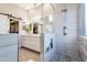 Bright bathroom featuring double vanity, a shower with tile surround, and access to walk-in closet at 4422 E Spur Dr, Cave Creek, AZ 85331
