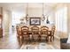 Elegant dining room with a large wooden table, upholstered chairs, and stylish lighting fixtures enhances mealtime ambiance at 4422 E Spur Dr, Cave Creek, AZ 85331