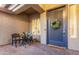 Charming front entrance with a brick-paved patio and dark blue door decorated with a floral wreath at 4422 E Spur Dr, Cave Creek, AZ 85331
