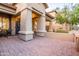 Cozy front porch with brick-paved patio, decorative wreath, and a small seating area with a bistro table at 4422 E Spur Dr, Cave Creek, AZ 85331
