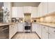 Well-equipped kitchen featuring white cabinets, stainless steel appliances, and stylish countertops with barstool seating at 4422 E Spur Dr, Cave Creek, AZ 85331