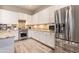 Bright kitchen with white cabinets, stainless steel appliances, and granite countertops provides ample cooking space at 4422 E Spur Dr, Cave Creek, AZ 85331