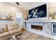 Cozy living room featuring a modern fireplace, entertainment center, and ample natural light exudes relaxation at 4422 E Spur Dr, Cave Creek, AZ 85331