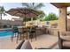 Outdoor kitchen and bar with seating, a built-in grill, fire pit and views of the sparkling pool at 4422 E Spur Dr, Cave Creek, AZ 85331