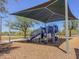 Community playground with sunshades, play equipment, and wood chip ground covering, perfect for Gathering fun at 4422 E Spur Dr, Cave Creek, AZ 85331
