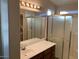 Bright bathroom featuring a vanity, sliding glass shower door, creating a relaxing and functional area at 4533 E Glenhaven Dr, Phoenix, AZ 85048